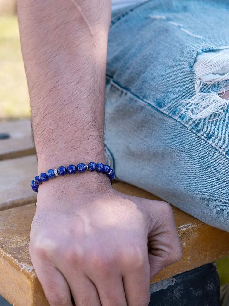 Men’s lapis lazuli beaded bracelet in blue with silver accents showcasing natural stone and metal details