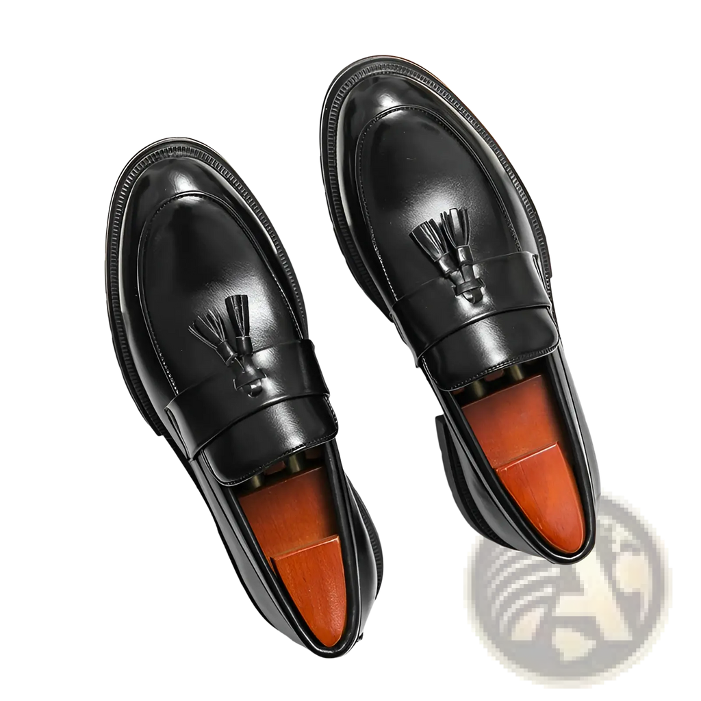 Men’s black leather tassel loafers with breathable orange insole and glossy brogue detailing for formal wear