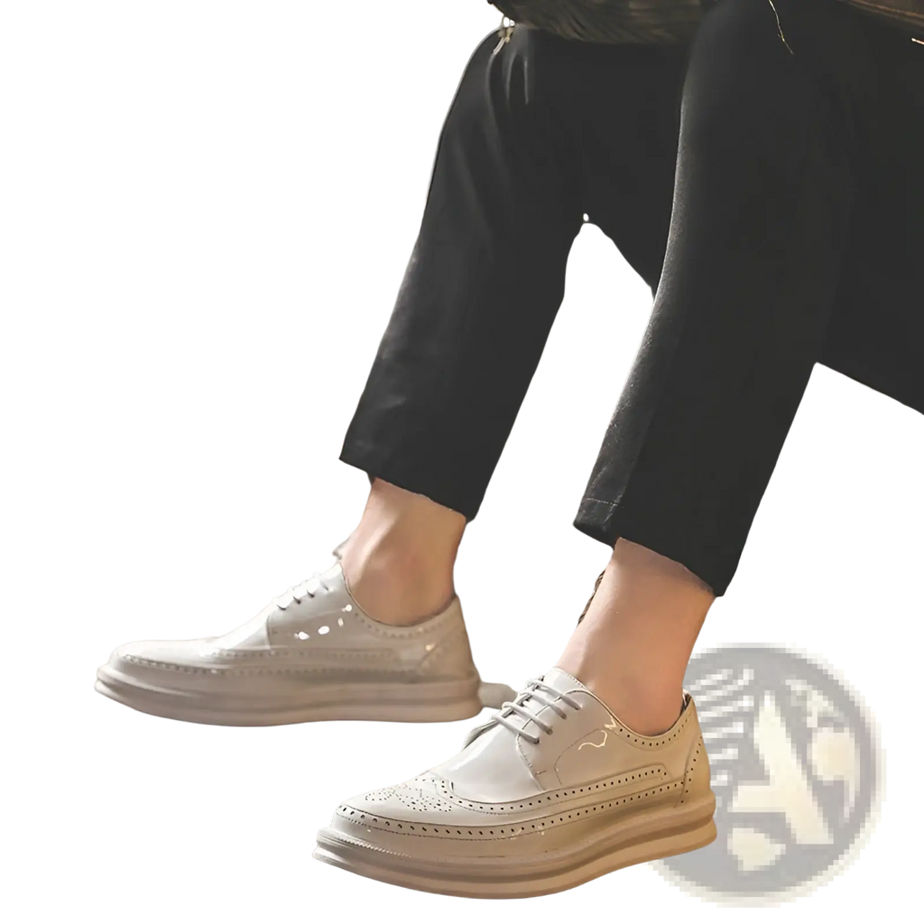 Cream-colored leather men’s brogue oxford shoes with perforated detailing and a chunky sole for business casual wear
