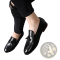 Men’s black leather tassel loafers with polished finish and subtle stitching details for formal wear