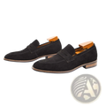 Men’s black suede loafers with classic slip-on design and contrasting tan leather soles for casual wear