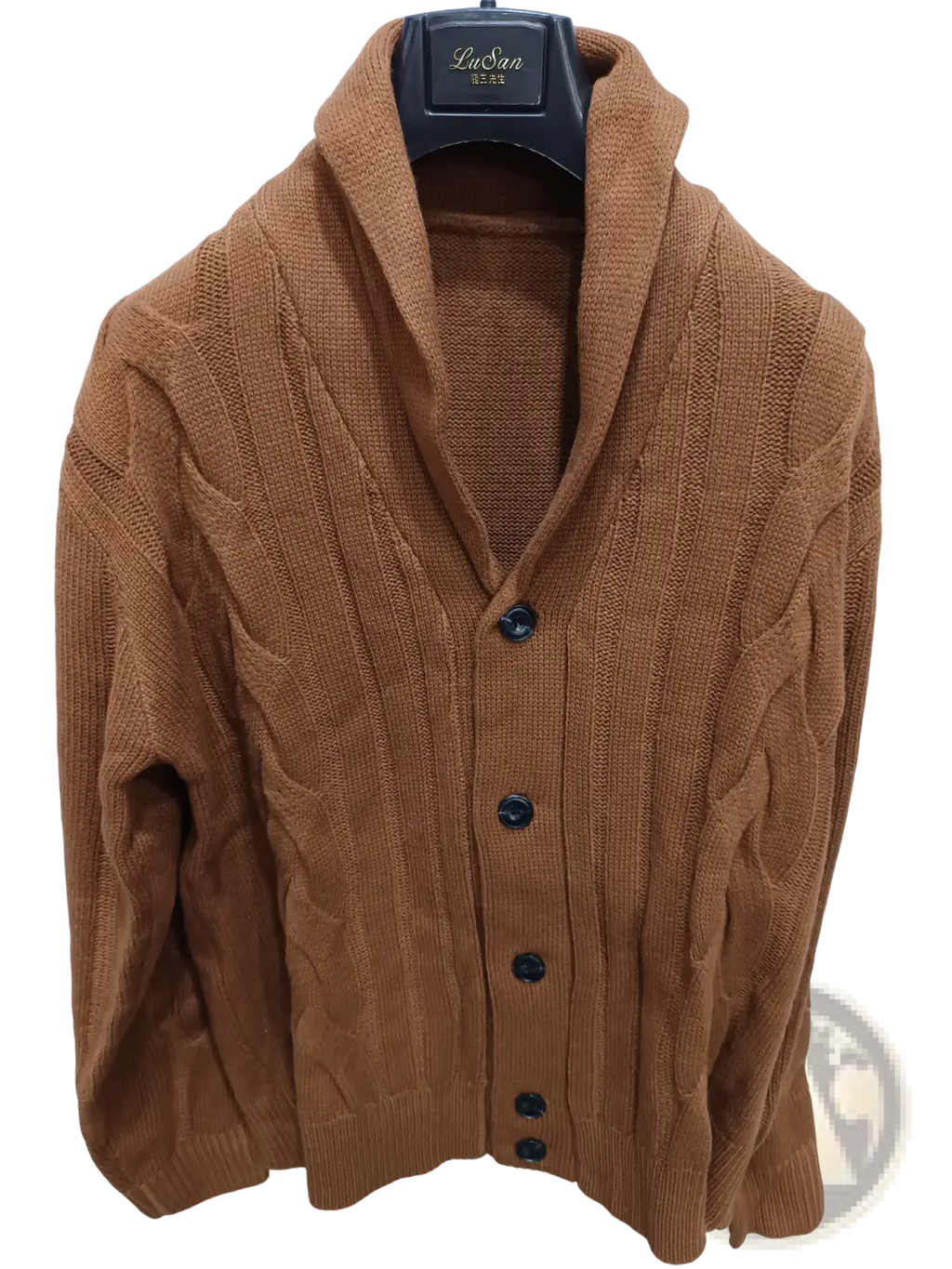 A warm brown cable knit shawl collar cardigan sweater with black buttons hanging on a black hanger
