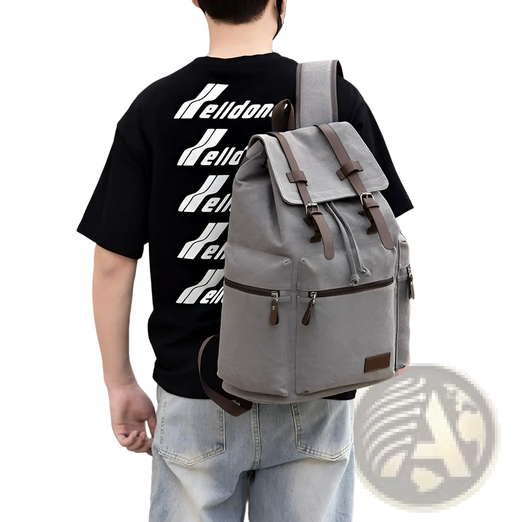 Men’s gray canvas travel backpack with brown leather straps and large 20-35l capacity for versatile use
