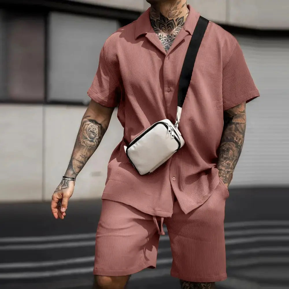 White crossbody bag with black strap and zipper details paired with men’s casual cotton polo and shorts summer set