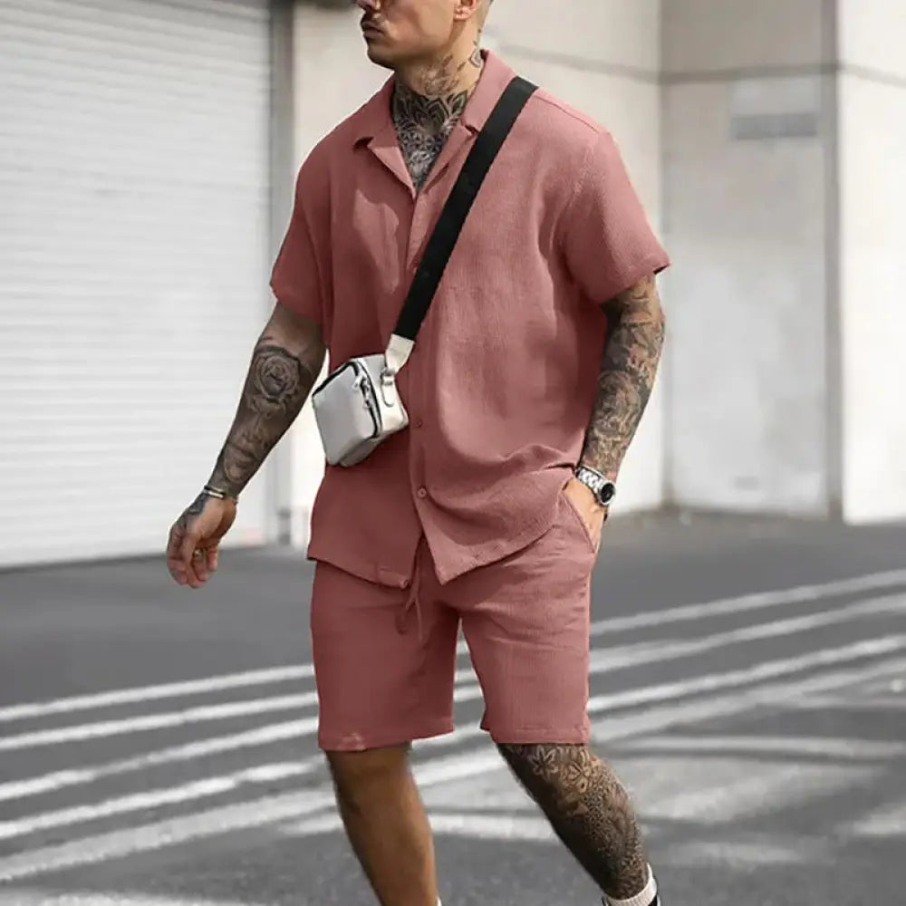 White crossbody bag with black strap paired with men’s casual cotton polo and shorts matching summer set