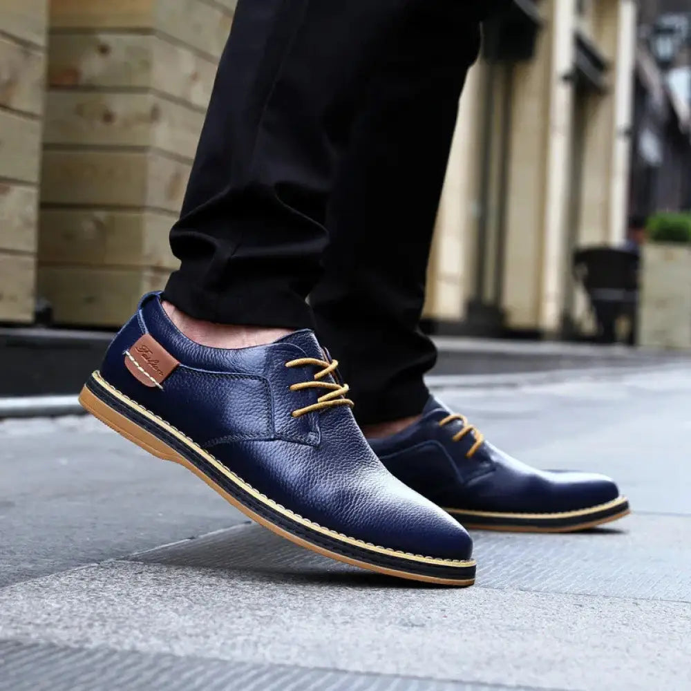 Men’s British leather lace-up dress shoes in navy blue with tan laces and matching tan sole