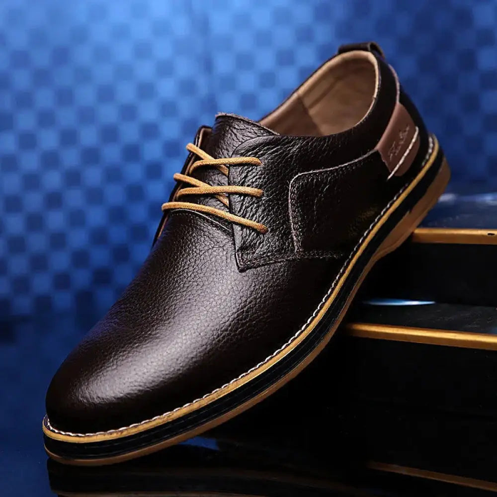 Men’s british leather lace-up dress shoes in dark brown with tan laces and contrasting light-colored sole