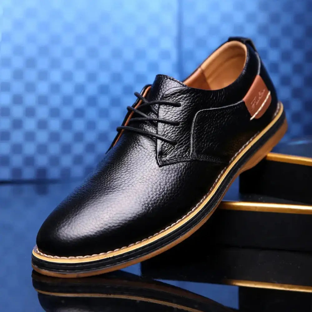 Men’s British leather lace-up dress shoe in black with tan accents and a textured finish