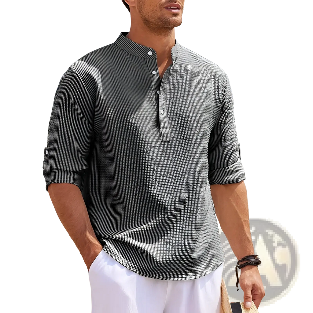 A man wearing a men’s casual ribbed cotton blend stand collar shirt in gray and black striped short sleeves with rolled cuffs