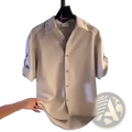 Mens casual short sleeve button down shirt in beige with rolled cuffs and subtle collar displayed on a hanger