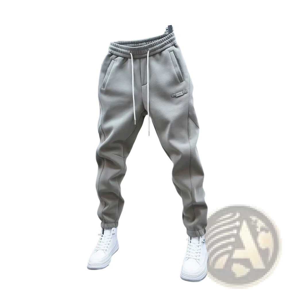 Mens casual solid color sweatpants in gray with white drawstrings and a small patch hanging on a metal rack