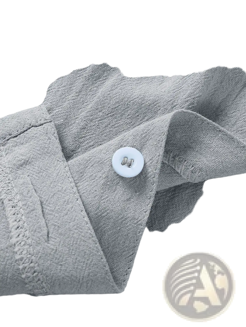 A white round button with a metallic sheen on the gray textured fabric of a men’s casual short sleeve button down shirt