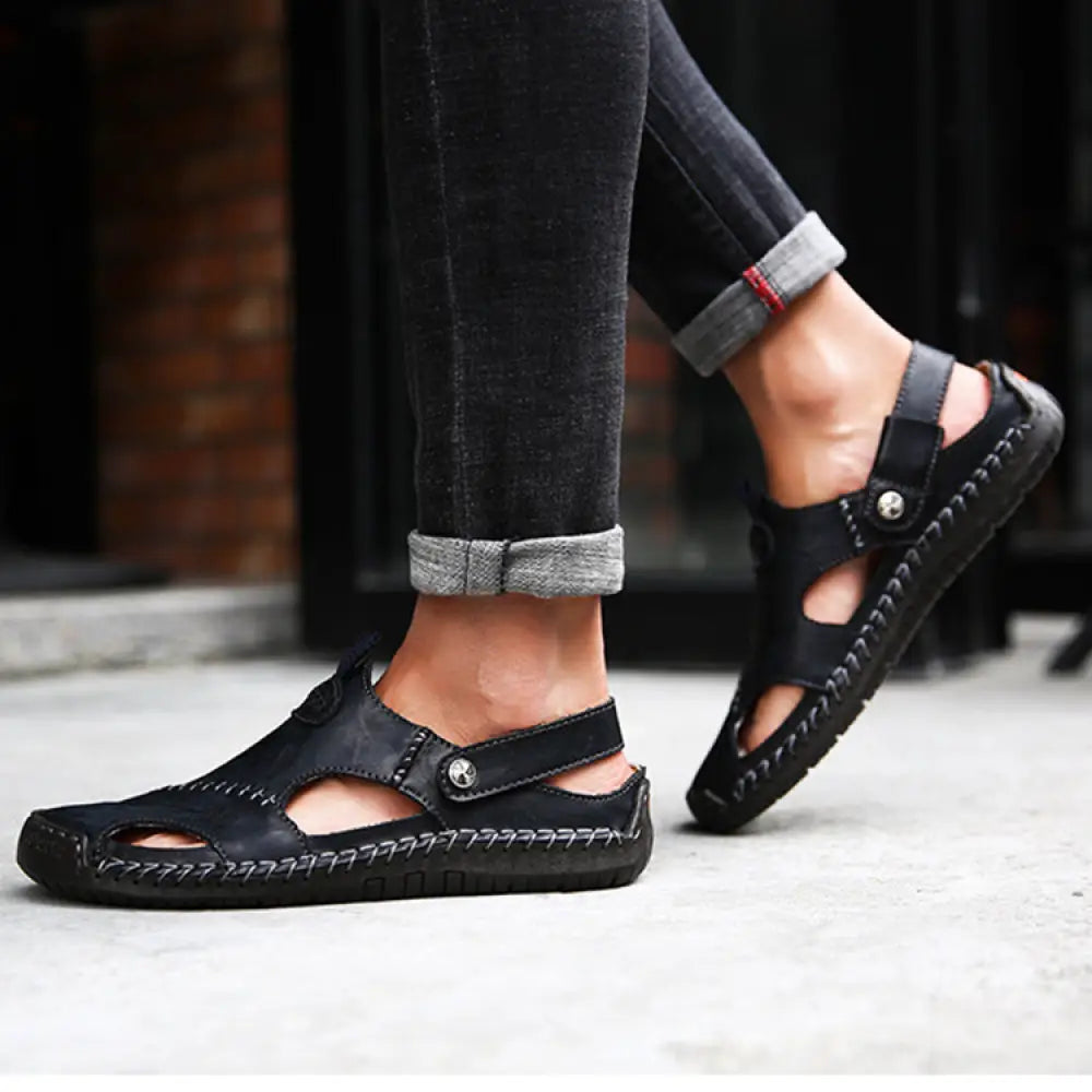 Men’s brown woven leather closed toe beach sandals with black leather stitched detailing and buckle strap