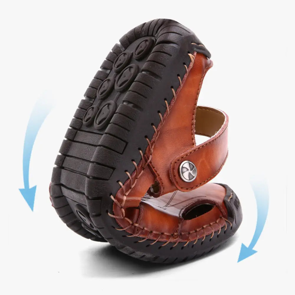 Men’s brown woven leather closed toe beach sandals with black rubber sole and visible stitching details