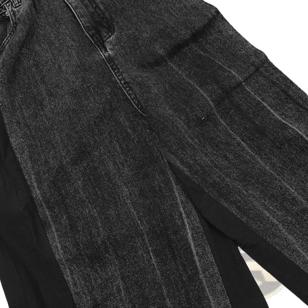 Men’s black denim joggers with contrast panels elastic waist faded distressed texture and visible seam stitching