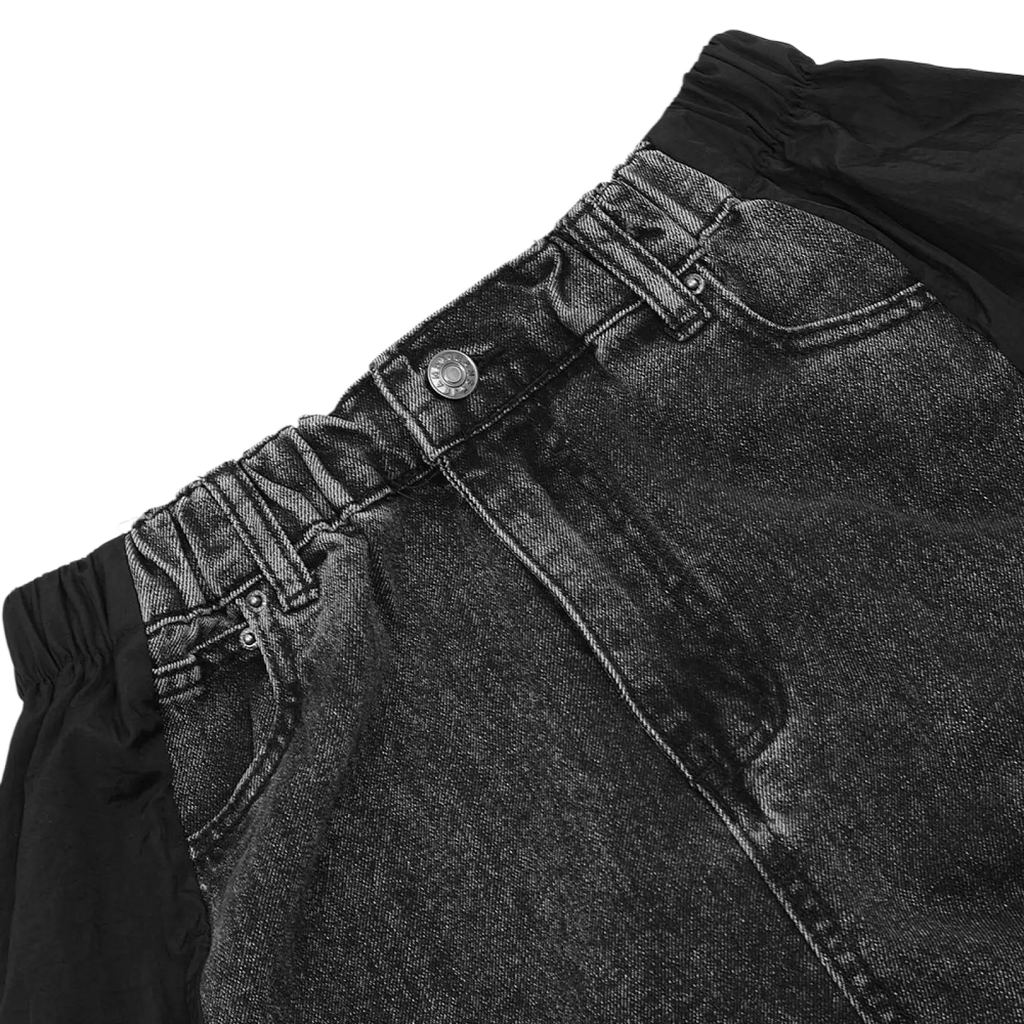 Men’s black denim joggers with elastic waistband and silver button featuring contrast panel design