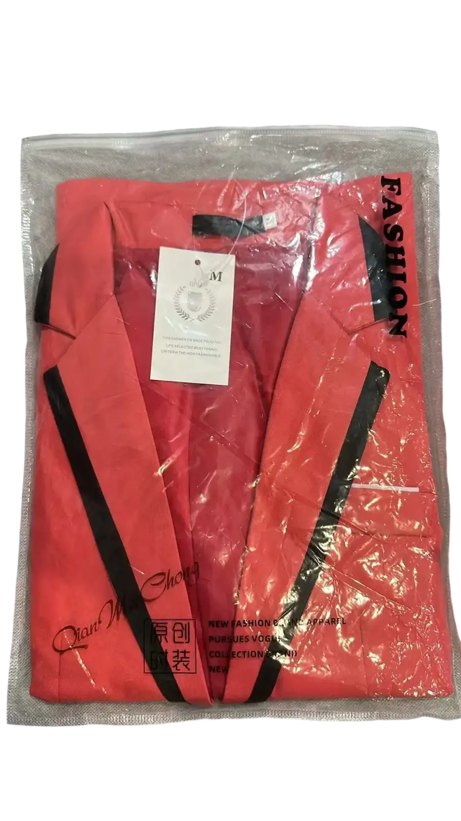 Men’s coral-red casual suit blazer jacket with bold black trim along lapels and front edges in clear plastic packaging