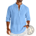 Men’s light blue cotton linen long sleeve henley shirt with subtle textured fabric and rolled cuffs