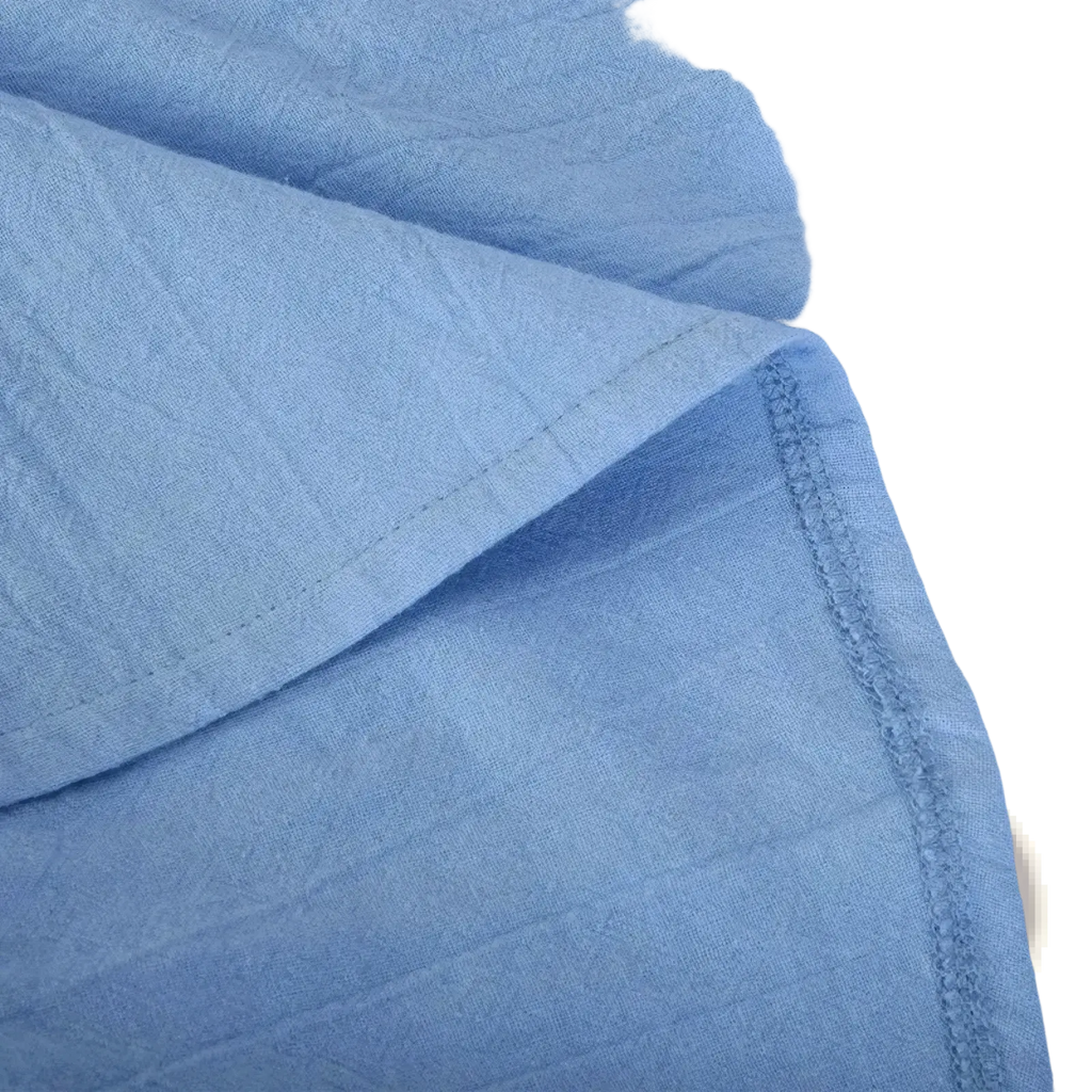 Light blue textured cotton fabric with visible stitching on the men’s cotton linen sleeveless button-up shirt