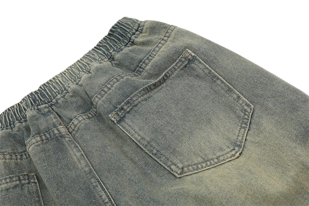 Back side of men’s light-wash diagonal strap denim shorts with elastic drawstring waistband and classic back pocket