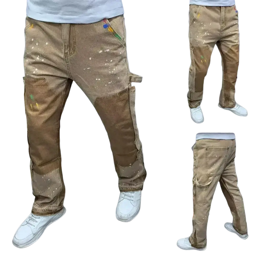 Mens distressed bell bottom denim work pants in tan with paint splatter details and reinforced patchwork panels