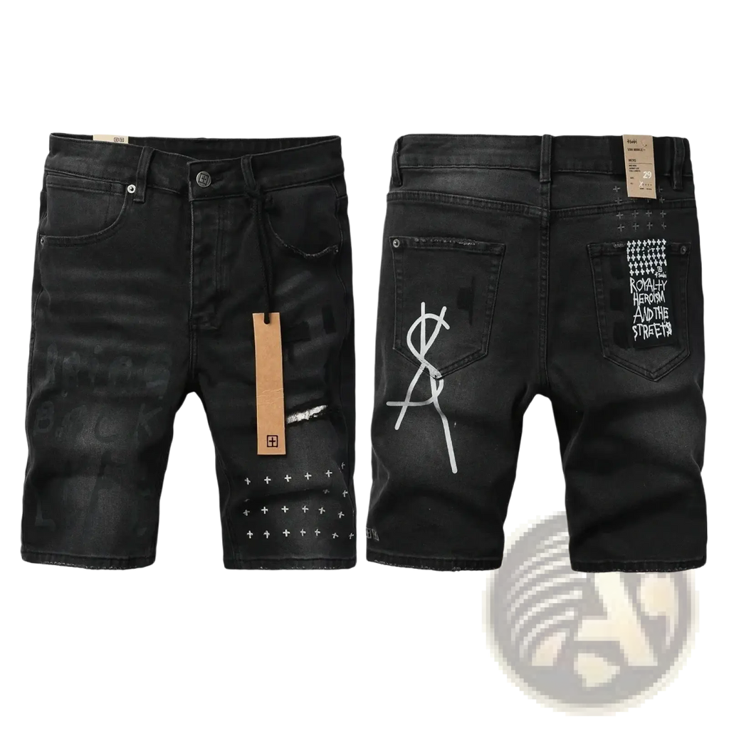 Back view of men’s distressed blue acid wash denim shorts with white graffiti graphics and studded crosshatch hem detail
