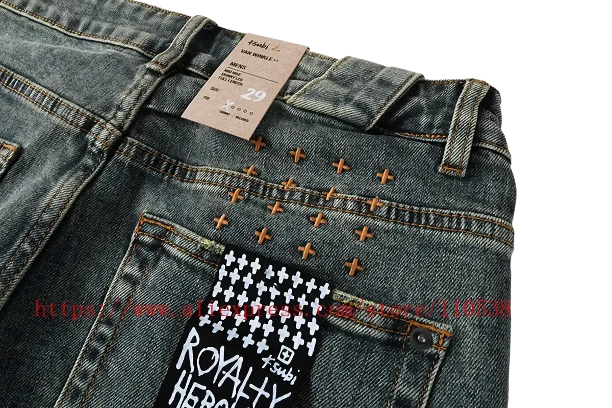 Back side of men’s distressed blue acid wash denim shorts with tan cross-stitch details and royalty heroes branded tag