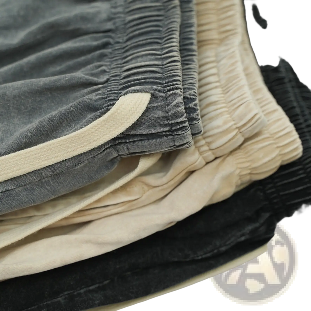 Stacked mens distressed cotton shorts in gray beige and black corduroy with contrasting cream elastic waistbands for summer