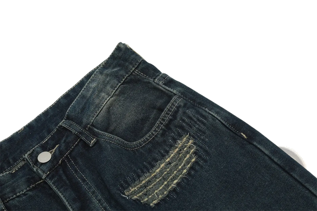 Men’s distressed dark wash straight leg ripped jeans with visible stitching, distressed patch, and silver button