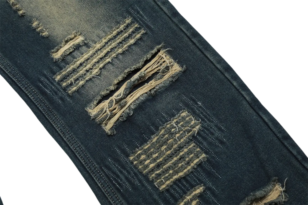 Men’s distressed dark wash straight leg denim jeans with frayed tear patches beige stitching and raw edges