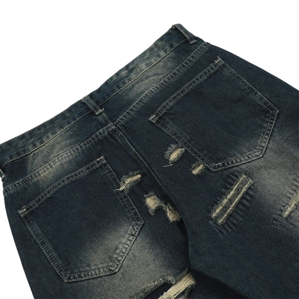 Men’s distressed dark wash straight leg denim jeans showing the back side with frayed patches and ripped pockets