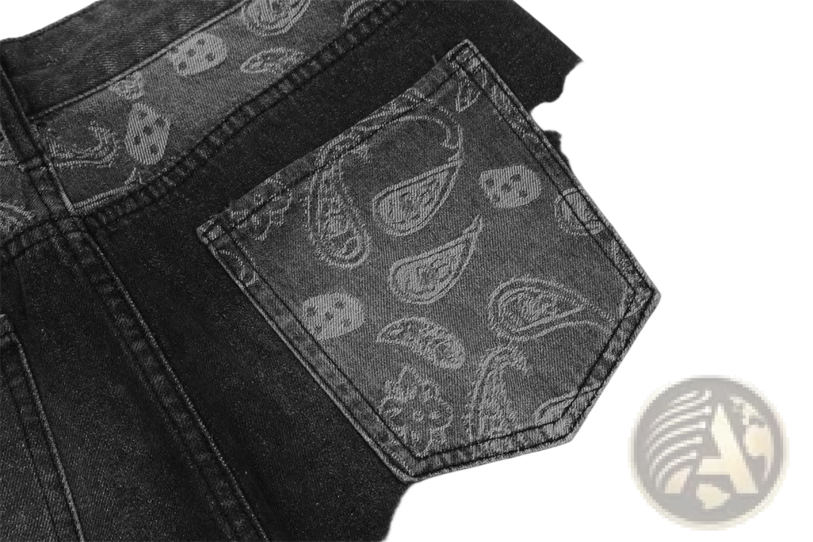 Back side of men’s distressed paisley patchwork flare black denim jeans with subtle paisley and skull pattern on pocket