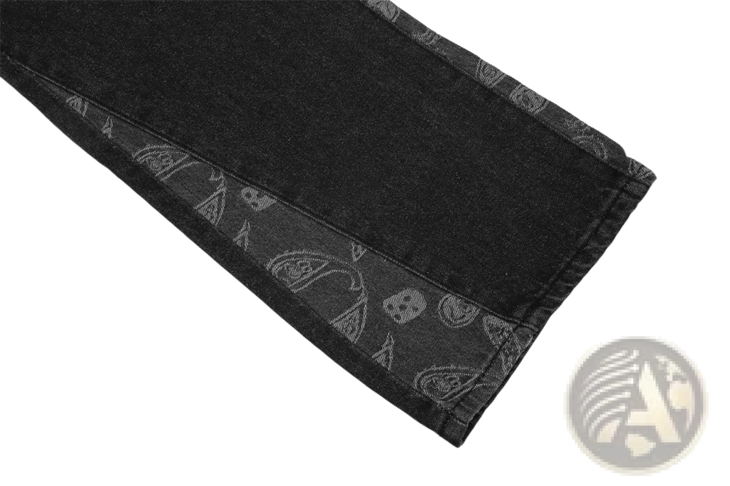 Men’s black denim distressed paisley patchwork flare jeans with subtle gray skull and paisley pattern on side seam