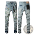 Men’s distressed slim fit light-wash denim jeans with camouflage patches and a black pocket patch visible from the back