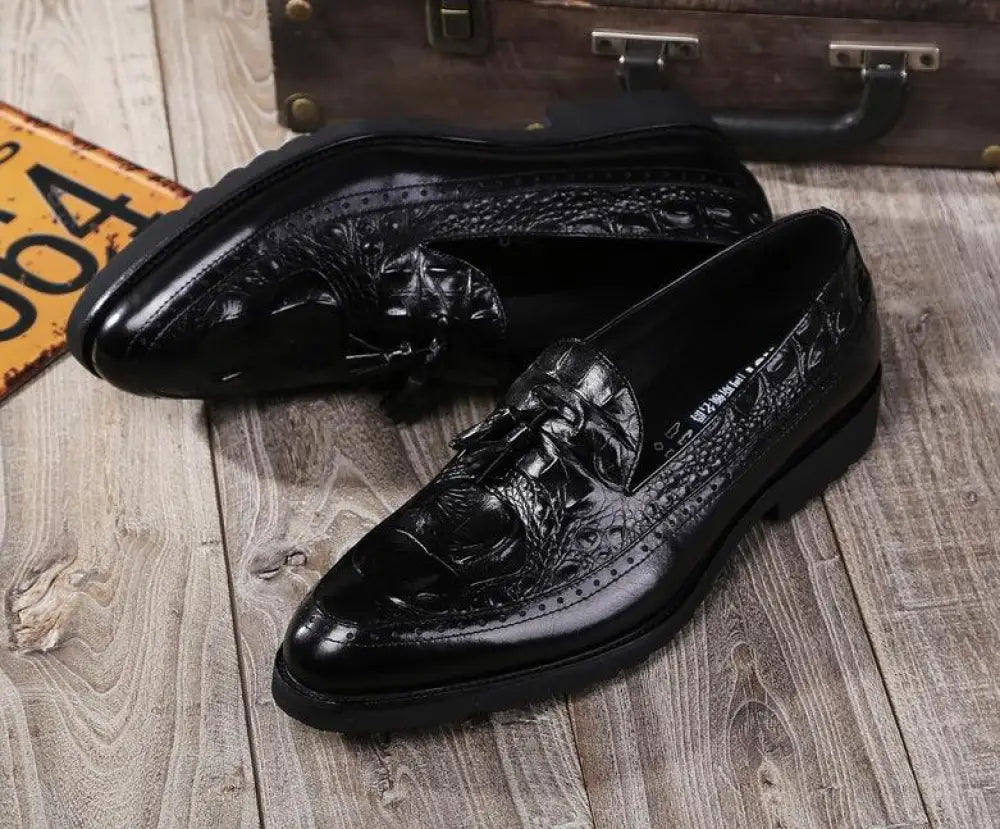 Black leather lace-up loafers with embossed crocodile skin pattern and decorative broguing for men