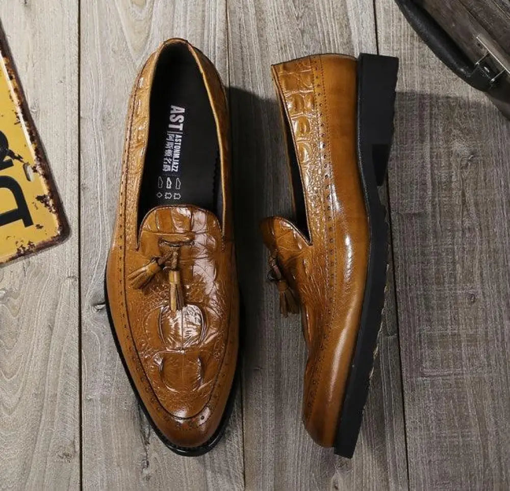 Men’s brown leather tassel loafers with crocodile embossing showcasing elegant brogue details
