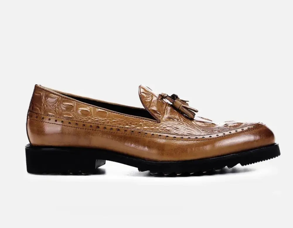 Men’s tan leather loafer with crocodile embossed texture and decorative tassel on the vamp in brogue style