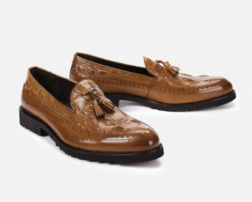 Men’s brown leather tassel loafers with crocodile embossed detailing and a glossy finish