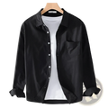 Men’s durable black long sleeve work shirt with chest pocket and rolled cuffs displayed on a wooden hanger