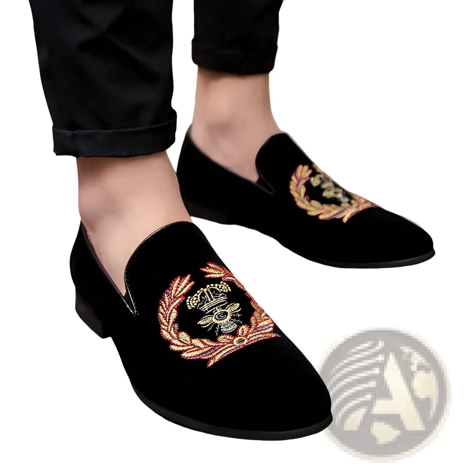 Men’s black velvet loafers with intricate gold and red embroidered laurel wreath and central crown design