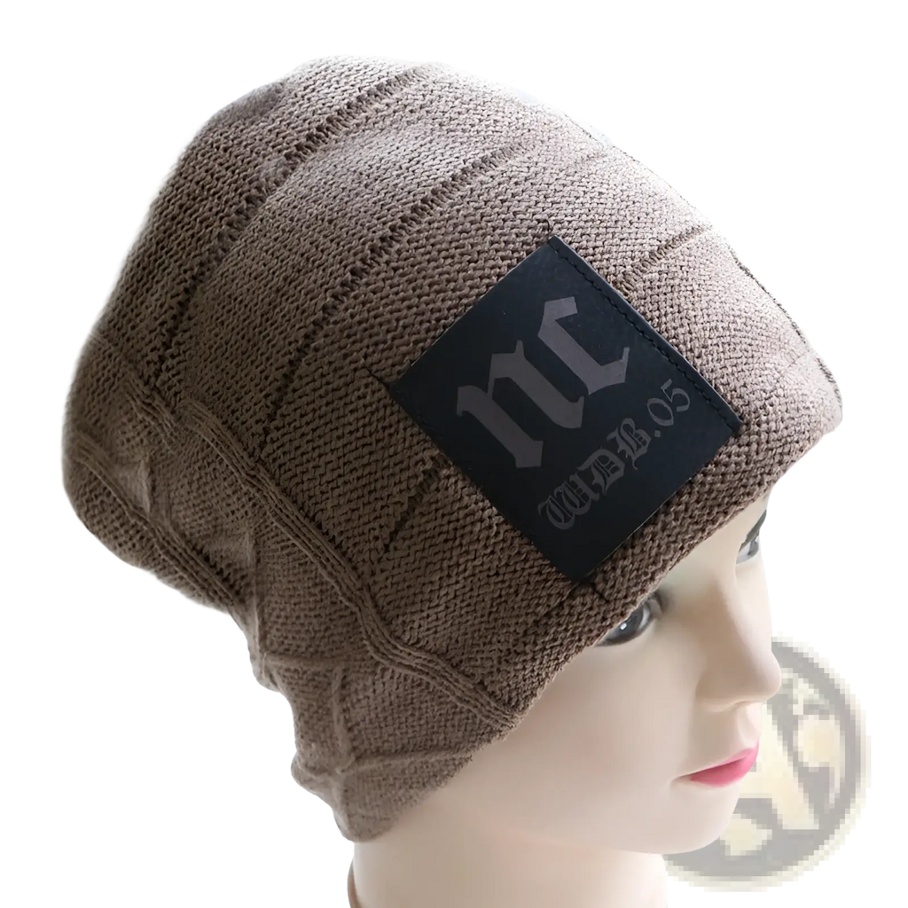 Beige fleece lined knitted men’s winter beanie hat with black wdb.05 logo patch displayed on mannequin head