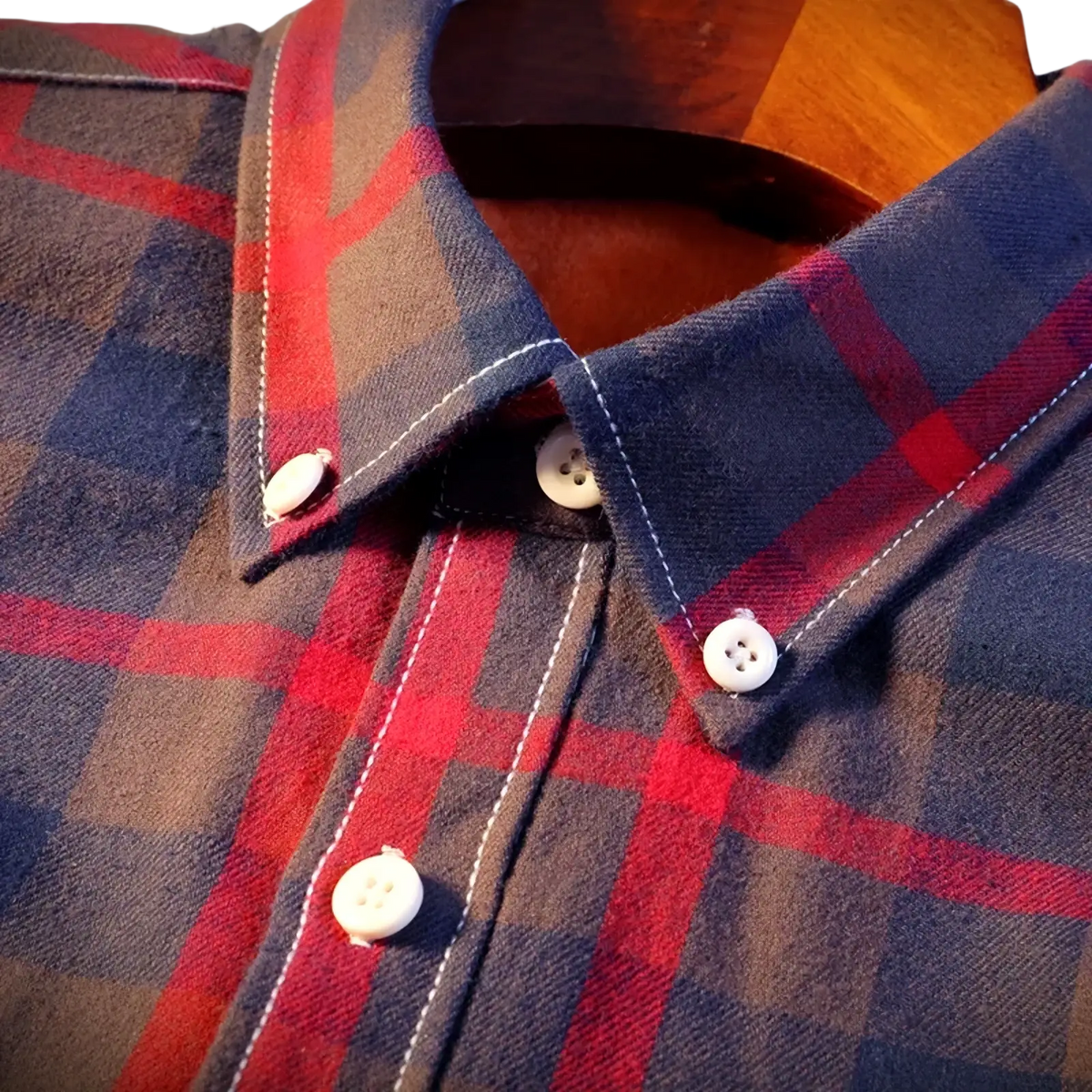 Men’s fleece lined plaid flannel shirt in navy blue red and brown with white buttons and contrasting stitching