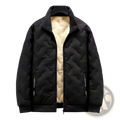 Men’s black quilted winter vest with plush beige fleece lining and subtle vertical text on side pocket detailing