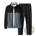 Men’s black and gray geometric two-piece athletic set with zip-up jacket and matching drawstring pants for spring casual wear