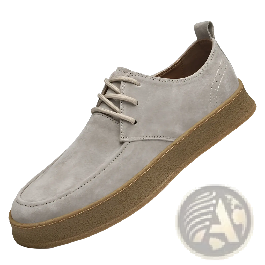 Men’s gray suede lace up casual flat shoe with tan rubber sole and matching laces in a side view