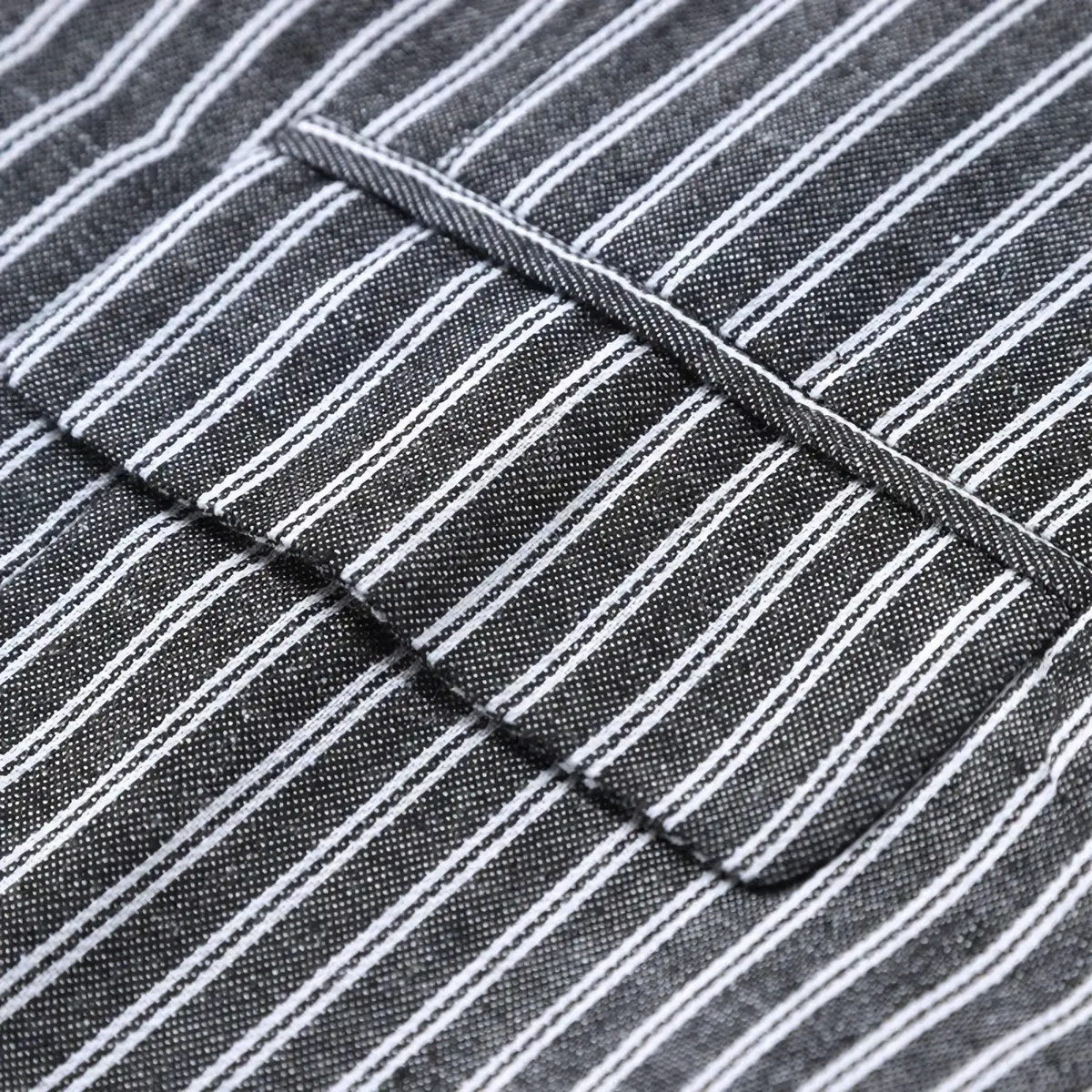 A close-up of a men’s grey striped double-breasted business vest with dark gray and white pinstripe fabric and stitched seams