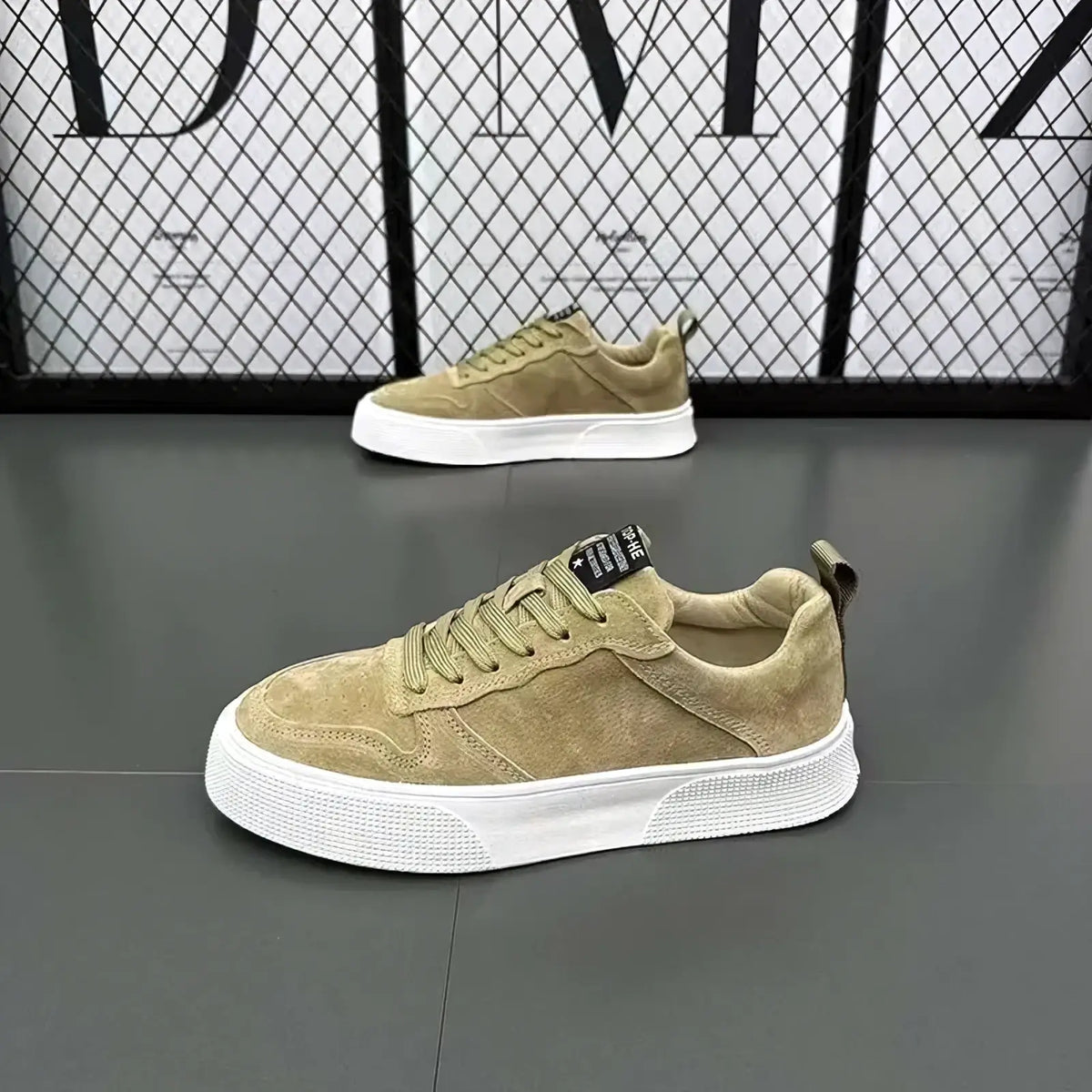 Men’s leather casual low top sneakers in olive suede with white rubber sole and black branding tag