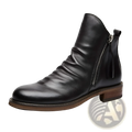 Men’s black leather ankle Chelsea boot with side zipper and small tassel heel detail visible from the side
