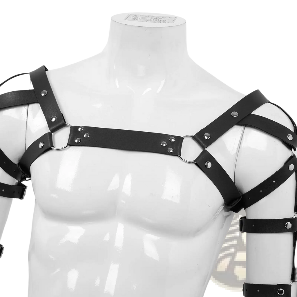 Men’s black leather chest harness with adjustable straps featuring silver-toned metal rings and studs