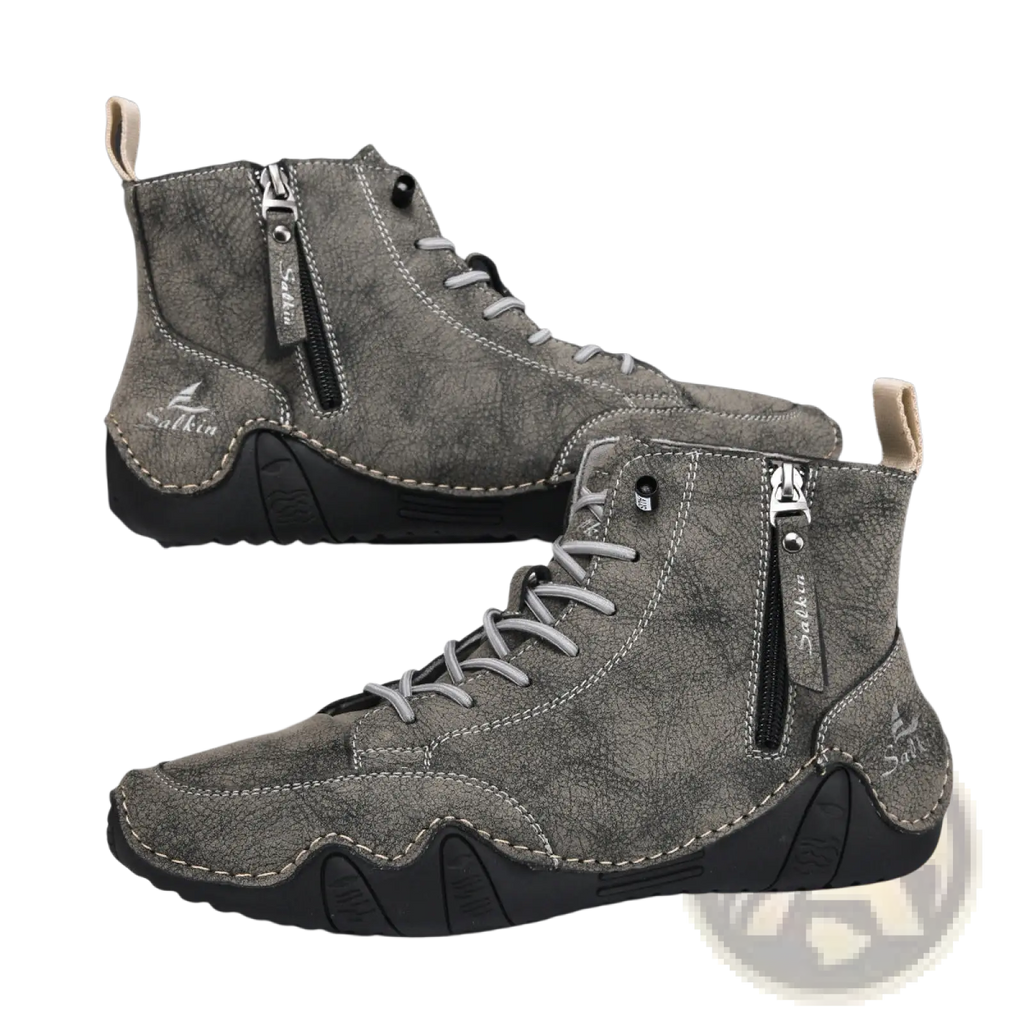 Men’s gray suede high top boots with black rubber soles silver laces and side zipper for easy wear